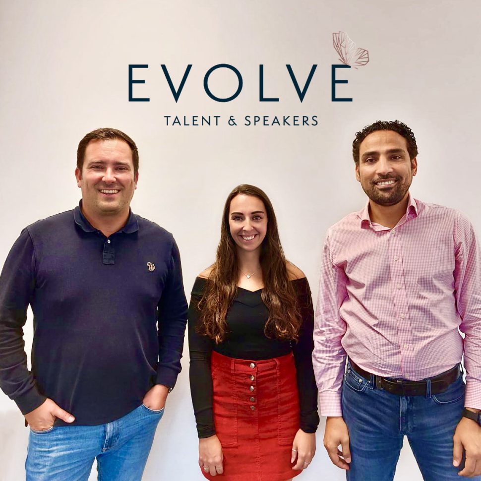 Benny, Jo Foster, and Amad Tababa standing infront of Evolve logo